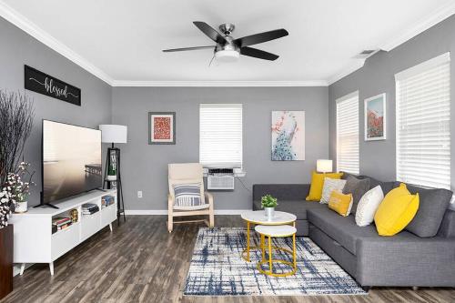 a living room with a couch and a tv at Unique Cozy Home 6 Min 2 Uptown Fire Pit & Yard in Charlotte