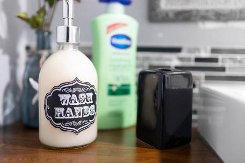 a bottle of wash hands detergent and a soap dispenser at Unique Cozy Home 6 Min 2 Uptown Fire Pit & Yard in Charlotte