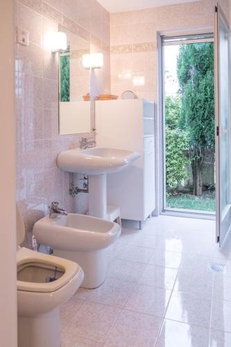 a bathroom with a toilet and a sink and a toilet at Villa Alberi with pool in Savudrija