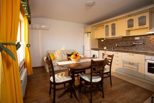 a kitchen with a table and chairs in a room at Guest House Arima in Sushina