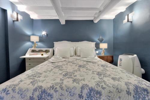 a bedroom with a large bed with blue walls at Santo Spirito Romantic in Florence