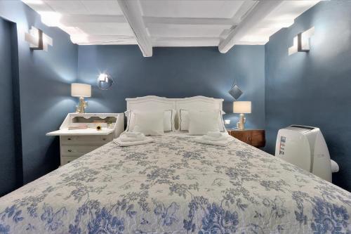 a bedroom with a large bed with blue walls at Santo Spirito Romantic by Mmega in Florence