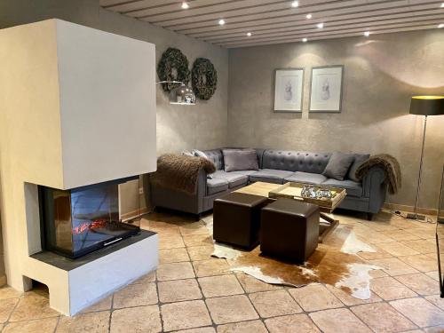 a living room with a couch and a fireplace at country-suites by verdino LIVING - Apartments & Privatzimmer in Braunlage
