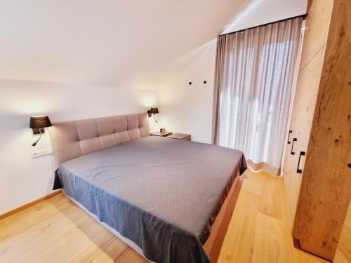 a bedroom with a large bed and a window at Mei-Chalet in Bad Kleinkirchheim