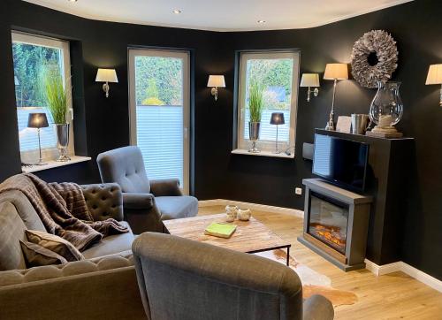 a living room with a couch and a fireplace at country-suites by verdino LIVING - Apartments & Privatzimmer in Braunlage