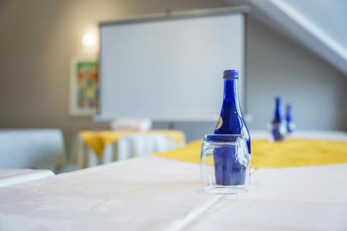 a blue bottle sitting on top of a table at Aberystwyth Park Lodge Hotel in Aberystwyth