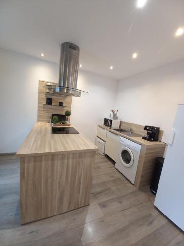 a kitchen with a stove and a washing machine at afa butrone sarrola in Afa