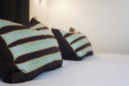 two pillows sitting on top of a bed at Aberystwyth Park Lodge Hotel in Aberystwyth