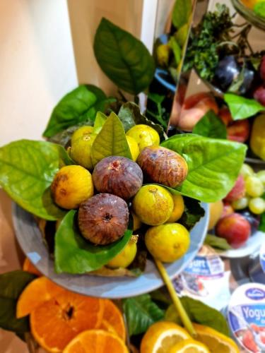 a plate of fruits and vegetables on a table at Casa Dominova de Luxe in Sorrento