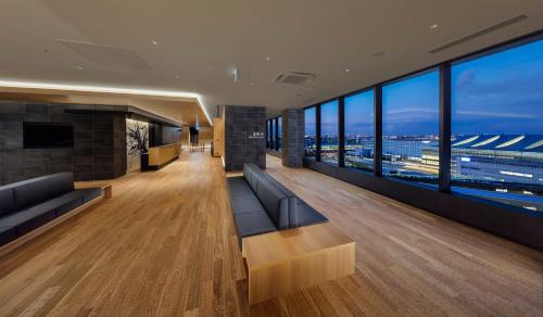 a lobby of a building with a view of the city at Villa Fontaine Grand Haneda Airport in Tokyo