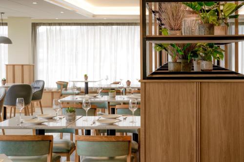 a dining room with white tables and chairs at Aberystwyth Park Lodge Hotel in Aberystwyth