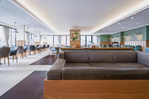 a living room with a couch and a bar at Aberystwyth Park Lodge Hotel in Aberystwyth