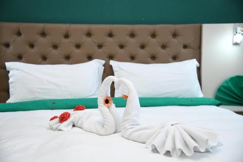 two swans made out of towels on a bed at Gold Felicia in Bitola