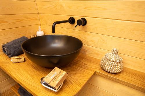 a black bowl on top of a wooden counter at Cliff Stud Retreat - Luxury lodges and cosy cottages in Helmsley