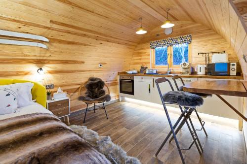 a log cabin with a kitchen and a living room at Cliff Stud Retreat - Luxury lodges and cosy cottages in Helmsley