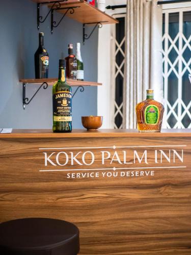 a bar with bottles of alcohol on a counter at KoKo Palm Inn LTD in Accra