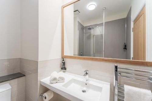 a bathroom with a sink and a mirror at Aberystwyth Park Lodge Hotel in Aberystwyth
