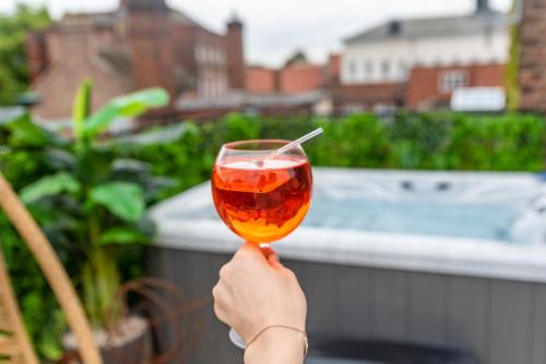 a person holding up a glass with a drink at Impossible Motel in York