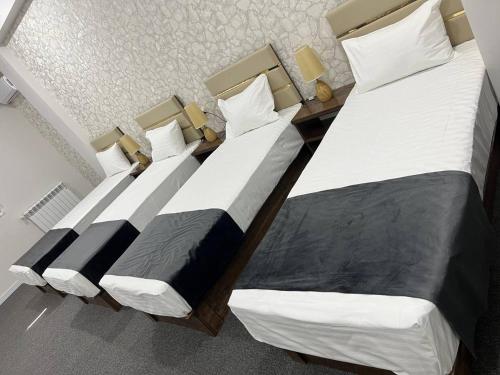 two beds sitting next to each other in a room at TASHRIF HOTEL in Qarshi