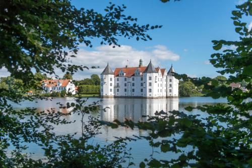 a castle in the middle of a lake at Ferienwohnung Fördeglück in Glücksburg