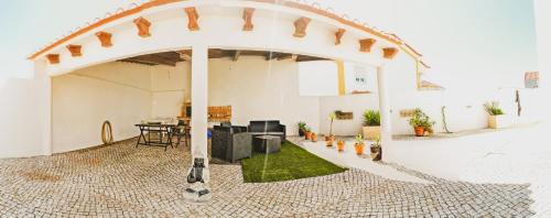 une arche dans un bâtiment avec une table et des chaises dans l'établissement Cosmos Retreat Baleal, à Baleal