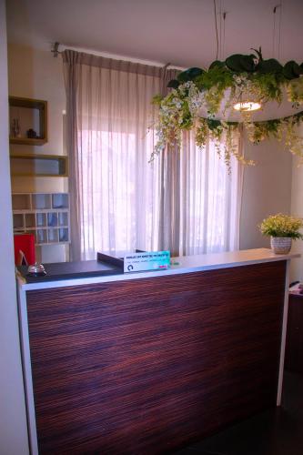 an office with a wooden counter with a window at Hotel La Villette in Antananarivo
