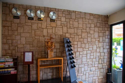 a brick wall with four clocks on it at Hotel La Villette in Antananarivo