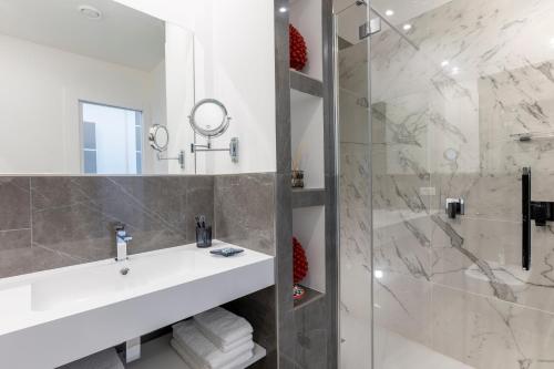 a bathroom with a sink and a shower at La Musa Apartments & Rooms in Palermo