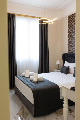 a bedroom with a large bed with a large window at Modern Revival Luxury Hotel in Thessaloniki