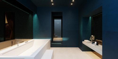 a bathroom with a large tub and a blue wall at relais metis in Naples