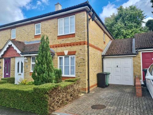 a brick house with a garage and a driveway at Delight Marvel- Beech Hurst-3 bedroom house in Maidstone