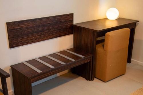 a room with a wooden desk and a chair at Hotel La Villette in Antananarivo