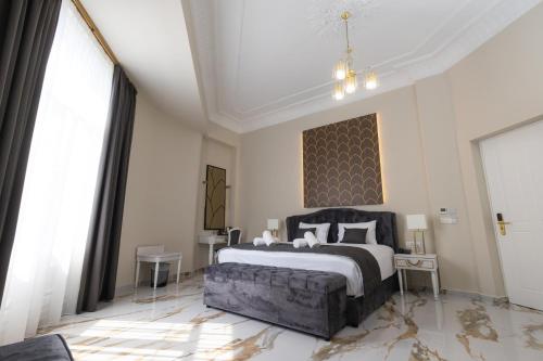 a bedroom with a large bed and a large window at Modern Revival Luxury Hotel in Thessaloniki