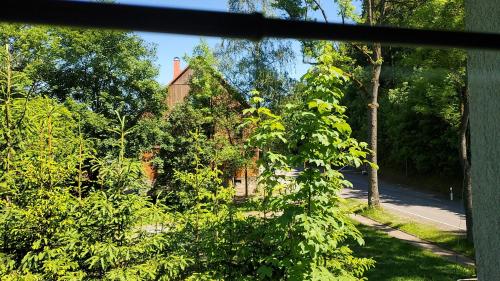 a view of a house from a window at Hotel Bielatal in Olbernhau