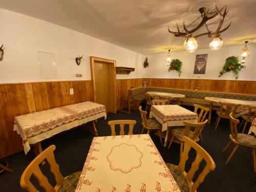 a restaurant with tables and chairs and a bar at Hotel Bielatal in Olbernhau