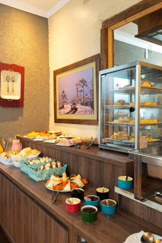 a buffet line with different types of food on display at Pousada UpSerra in Urubici