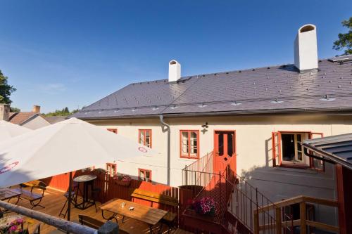 a house with a patio with a table and an umbrella at Měšťanský dům - kulturní památka Mlýnská 119 in Jindrichuv Hradec