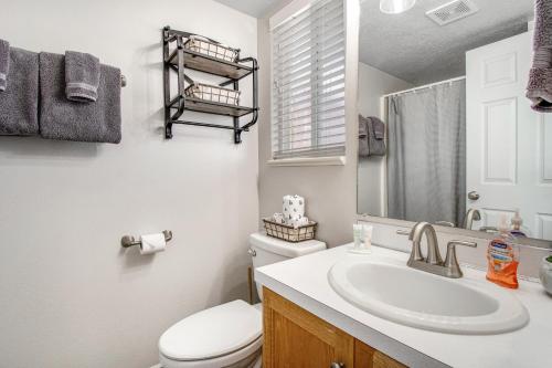 a bathroom with a sink and a toilet and a mirror at Bear Lake Blue in Garden City