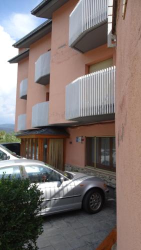 a silver car parked in front of a building at Hotel Restaurante La Glorieta in La Seu d'Urgell