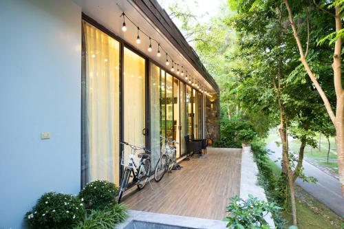 a house with a bike parked on a porch at Villa Đỗ Quyên F5B in Ngọc Quang