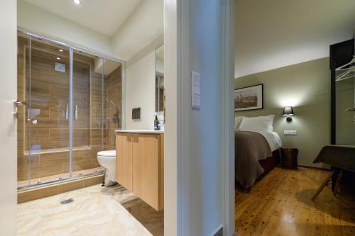 a bathroom with a bed and a sink and a toilet at City Cottage - Kalamata Villas in Kalamata