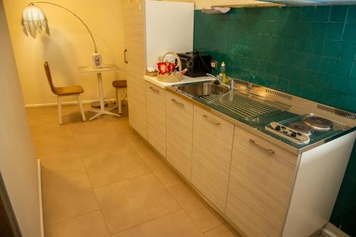 a kitchen with a sink and a counter top at Hotel La Villette in Antananarivo