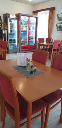 a table in a restaurant with chairs and drinks at Penzion U Skály in Kytlice