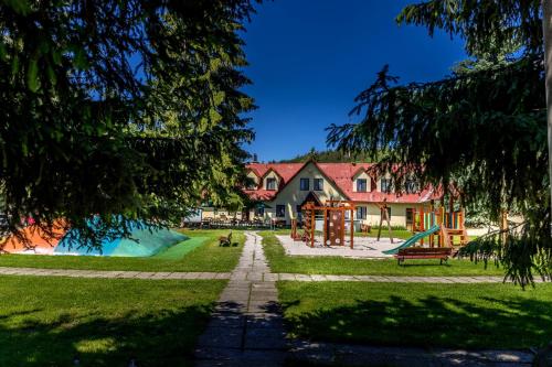 a park with a playground and a house at Penzion U Skály in Kytlice