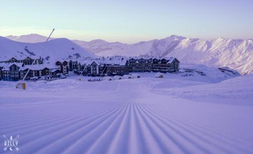 a resort in the middle of a snow covered mountain at 7 Senses Luxury Apartment in Gudauri