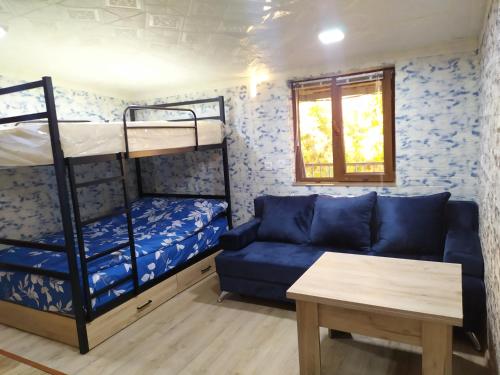 a living room with a couch and bunk beds at COZY HOTEL SKS in Yerevan