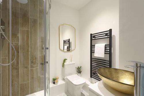 a bathroom with a shower and a sink and a tub at Bressingham - 2 Bedroom Luxury Apartment by Mint Stays in Bristol