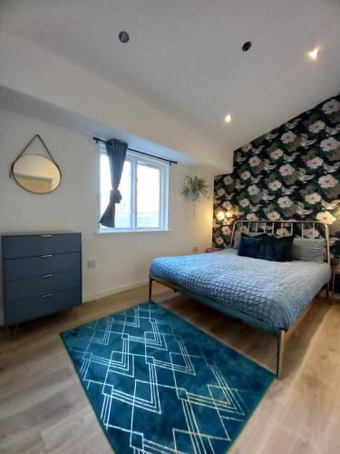 a bedroom with a bed and a blue rug at L2 Apartments- City Center- 2 bed in Liverpool