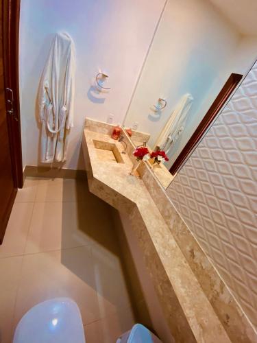 a bathroom with a sink and a toilet at VILLA TROPICAL LUX in Pipa