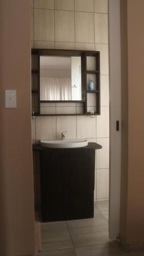 a bathroom with a sink and a mirror at LA CASETTA BED & BREAKFAST in Swakopmund